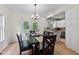 Open concept dining room featuring hardwood floors and adjacent to a kitchen with stainless steel appliances at 5237 Christian Light Rd, Fuquay Varina, NC 27526