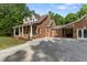 Two-story brick home with a full porch, complemented by an oversized parking area at 5237 Christian Light Rd, Fuquay Varina, NC 27526