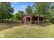 Horse stall with white cross-buck doors, wooden framing, and lush surroundings at 5237 Christian Light Rd, Fuquay Varina, NC 27526