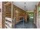Well-maintained horse stalls featuring wood paneling, brick accents, and overhead lighting for equestrian enthusiasts at 5237 Christian Light Rd, Fuquay Varina, NC 27526