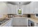 Bright kitchen featuring white cabinetry, gas range, granite countertops and stainless steel appliances at 5237 Christian Light Rd, Fuquay Varina, NC 27526