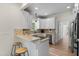 Charming kitchen with white cabinetry, gas range, stainless steel appliances, and breakfast bar with bar stools at 5237 Christian Light Rd, Fuquay Varina, NC 27526