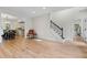 Spacious living room showcasing hardwood floors with dining area and stairs at 5237 Christian Light Rd, Fuquay Varina, NC 27526