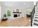 Bright living room featuring a white fireplace and wood floors at 5237 Christian Light Rd, Fuquay Varina, NC 27526