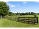 Open pasture featuring a combination of wood and metal fencing and an iron gate. Perfect for horses! at 5237 Christian Light Rd, Fuquay Varina, NC 27526