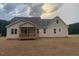 Single-story home showcasing a covered back patio with a backyard, perfect for outdoor relaxation and entertaining at 529 Mulberry Rd, Spring Hope, NC 27882
