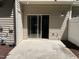 Outdoor patio area with sliding glass doors, a white fence, and space for entertaining at 532 Matheson Pl, Cary, NC 27511