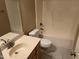 Bathroom featuring a single sink vanity, toilet and shower with tan-colored walls at 532 Matheson Pl, Cary, NC 27511