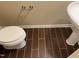 Bathroom featuring a pedestal sink, toilet, and dark wood-look tile flooring at 532 Matheson Pl, Cary, NC 27511