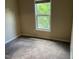 Bedroom features carpet and a window with views of the trees outside at 532 Matheson Pl, Cary, NC 27511