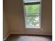 The bedroom has carpet and a window overlooking the trees at 532 Matheson Pl, Cary, NC 27511