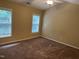 Neutral bedroom features plush brown carpeting, a ceiling fan, and two windows for natural light at 532 Matheson Pl, Cary, NC 27511