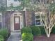 Charming front entrance with a red door, stone accents, and manicured landscaping at 532 Matheson Pl, Cary, NC 27511