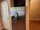 Stainless steel refrigerator in a modern kitchen adjacent to a doorway at 532 Matheson Pl, Cary, NC 27511