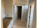 Bathroom featuring marble-tiled shower, white cabinets, and granite countertops at 539 Mulberry Rd, Spring Hope, NC 27882