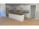 Spacious kitchen featuring white cabinets and a large island ready for finishing at 539 Mulberry Rd, Spring Hope, NC 27882