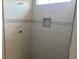 Marble-tiled shower with decorative accent strip and built-in niche at 539 Mulberry Rd, Spring Hope, NC 27882
