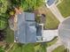 Aerial view of the house showing the roof, driveway, backyard patio, and surrounding greenery at 6 Beltre Ct, Durham, NC 27705