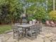 Outdoor patio with stone pavers, a dining table, and a built-in grill for entertaining at 6 Beltre Ct, Durham, NC 27705