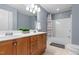 Well-lit bathroom with double sinks, a large mirror, and a shower-tub combination at 6 Beltre Ct, Durham, NC 27705