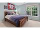 Inviting bedroom featuring a comfortable bed, natural light, and sports decor creating a personal and cozy space at 6 Beltre Ct, Durham, NC 27705