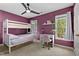 Stylish bedroom with a bunk bed, a desk by the window, and a modern ceiling fan creating a functional and appealing space at 6 Beltre Ct, Durham, NC 27705