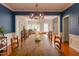 Open-concept dining area with wood floors, stylish lighting, and easy access to living areas at 6 Beltre Ct, Durham, NC 27705