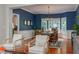 This formal dining room features dark blue accent walls, wainscotting, hardwood floors, and an elegant chandelier at 6 Beltre Ct, Durham, NC 27705