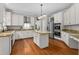 Bright kitchen with granite countertops, stainless steel appliances, and custom cabinets at 6 Beltre Ct, Durham, NC 27705
