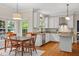 Bright kitchen with white cabinets, stainless steel appliances, and a dining area with backyard views at 6 Beltre Ct, Durham, NC 27705