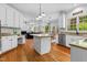 Spacious kitchen with white cabinets, granite countertops, stainless steel appliances and hardwood floors at 6 Beltre Ct, Durham, NC 27705