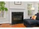 Cozy living room with fireplace and natural light streaming through the windows at 6 Beltre Ct, Durham, NC 27705
