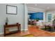Bright living room with hardwood floors, neutral walls and furniture, and a view into the adjacent dining room at 6 Beltre Ct, Durham, NC 27705