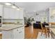 Open-concept living room connected to the kitchen features hardwood floors and a cozy fireplace at 6 Beltre Ct, Durham, NC 27705