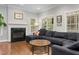 Comfortable living room featuring a fireplace, hardwood floors, and natural light from the windows at 6 Beltre Ct, Durham, NC 27705
