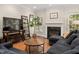 Living room with hardwood floors, fireplace, shelving, and a large plant that adds a touch of nature at 6 Beltre Ct, Durham, NC 27705