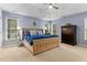 Spacious main bedroom with tray ceilings, large windows providing natural light, and a luxurious, comfortable king-size bed at 6 Beltre Ct, Durham, NC 27705