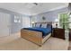 Bright main bedroom featuring a plush bed, neutral carpet, and large windows offering a serene and relaxing atmosphere at 6 Beltre Ct, Durham, NC 27705