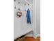 Functional mudroom area with coat hooks, a built-in bench, and storage basket for organization at 6 Beltre Ct, Durham, NC 27705