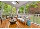 Relaxing screened porch with skylights, comfortable seating, and views of the lush backyard at 6 Beltre Ct, Durham, NC 27705