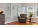 Cozy sitting area with lots of natural light, hardwood floors, and comfortable chair at 6 Beltre Ct, Durham, NC 27705