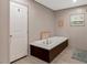 Relaxing bathroom with a standalone soaking tub and ample space at 6082 Zachary Lane Ln # 1S, Oxford, NC 27565