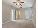 Neutral bedroom with three doors, carpet, and ceiling fan at 752 Wickham Ridge Rd, Apex, NC 27539