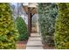 View of home's entrance with well-manicured landscaping and pavers leading to the front door at 752 Wickham Ridge Rd, Apex, NC 27539
