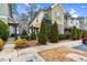A view of the townhome's facade, with landscaped front yard, sidewalk and partial view of adjacent home at 752 Wickham Ridge Rd, Apex, NC 27539