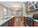 Kitchen with stainless appliances, granite counters, and a view of adjacent living space at 752 Wickham Ridge Rd, Apex, NC 27539