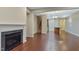 Living room boasts a fireplace, hardwood floors, with open floorplan that connects to dining and kitchen area at 752 Wickham Ridge Rd, Apex, NC 27539