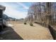 Large, fenced backyard featuring an expansive lawn and established perimeter trees at 76 Freewill Pl, Raleigh, NC 27603