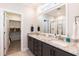 Bathroom features a double vanity with granite countertop, ample storage, large mirror, and walk-in closet at 76 Freewill Pl, Raleigh, NC 27603