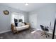 Stylishly decorated bedroom featuring a daybed, desk and a large window, creating a cozy and functional space at 76 Freewill Pl, Raleigh, NC 27603